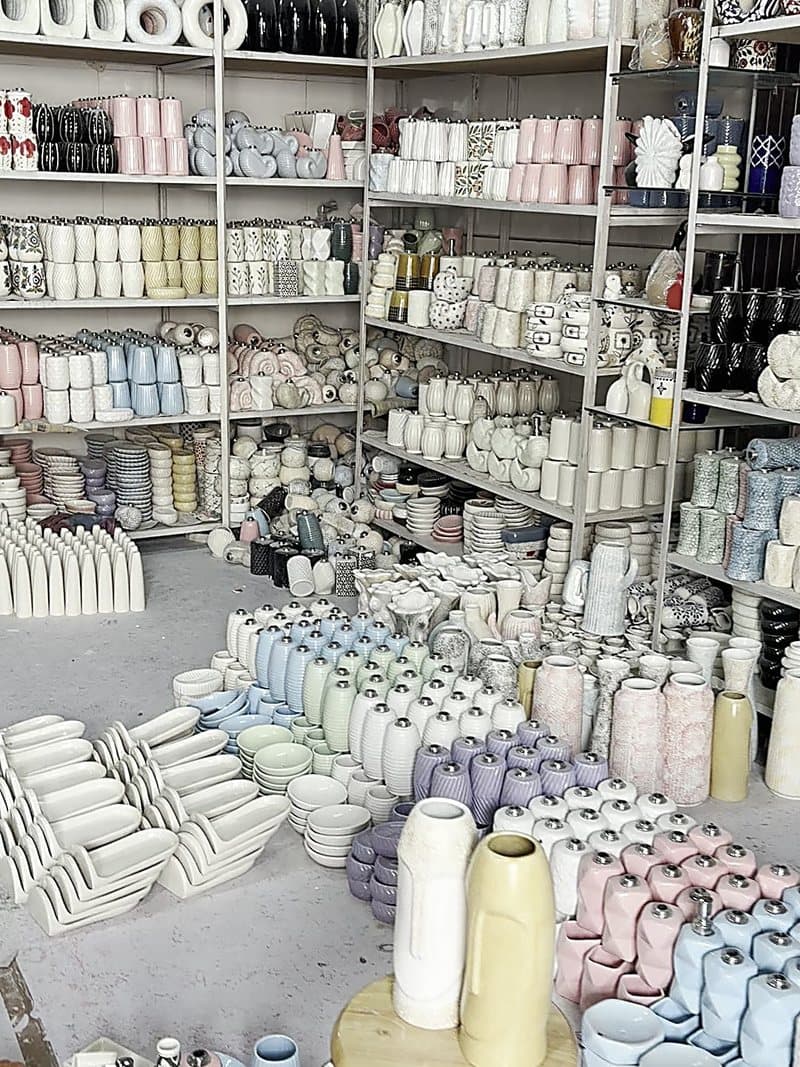 Racks of glazed ceramic pieces mid production run at the Khurja unit